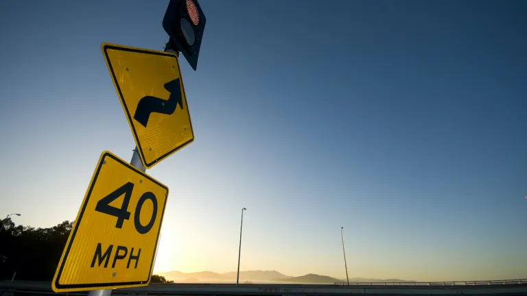 Street signs on the Bay Bridge indicating a 40 mile-per-hour zone and a curve ahead.