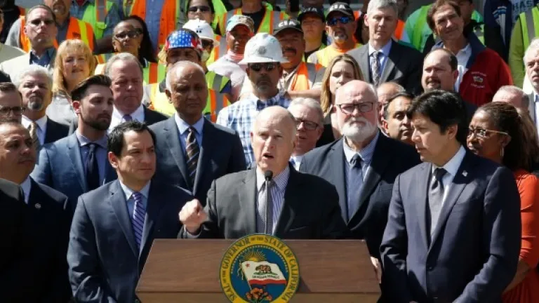 Calif., Gov. Jerry Brown, center, discusses a plan to raise $52 billion to fix California roads, during a news conference Wednesday, March 29, 2017, in Sacramento, Calif. (AP Photo/Rich Pedroncelli)