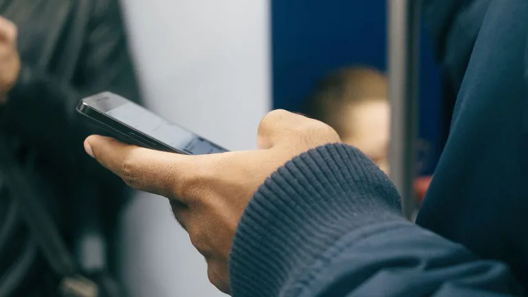 A hand holding a cell phone