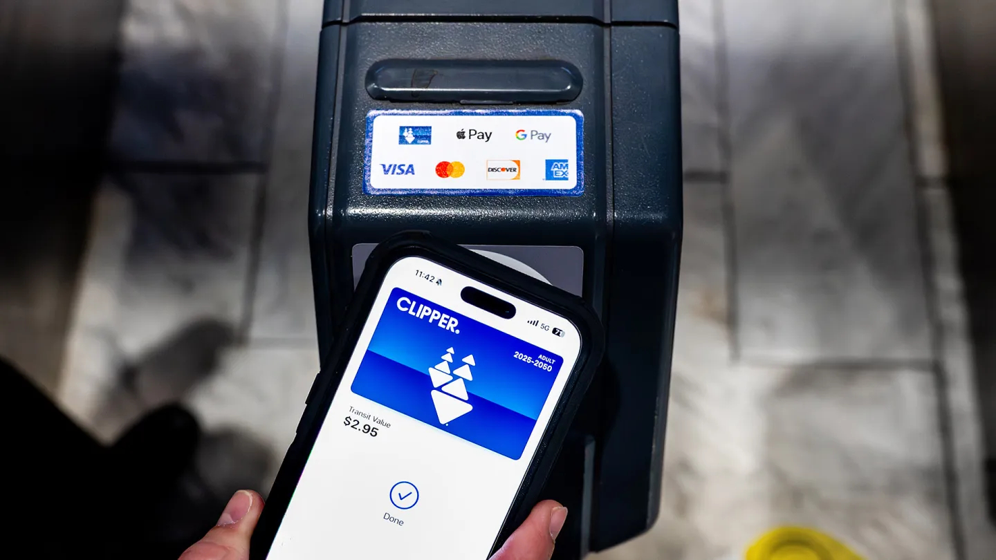 A person pays for transit fare using Clipper on their phone.