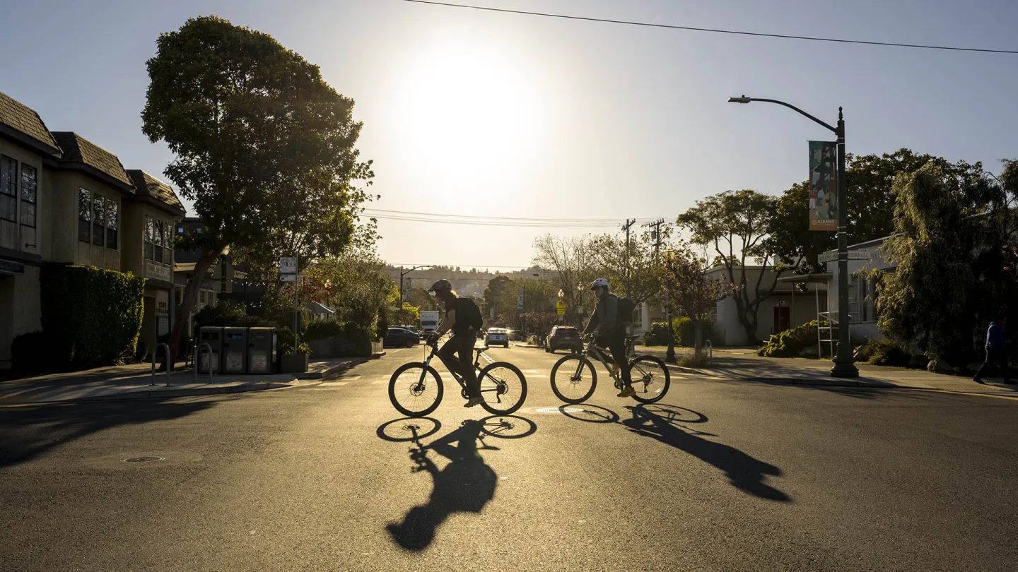 Silhouette of two cyclists in Albany.