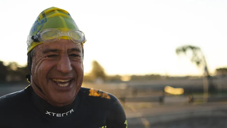 A person in a swim cap smiling.