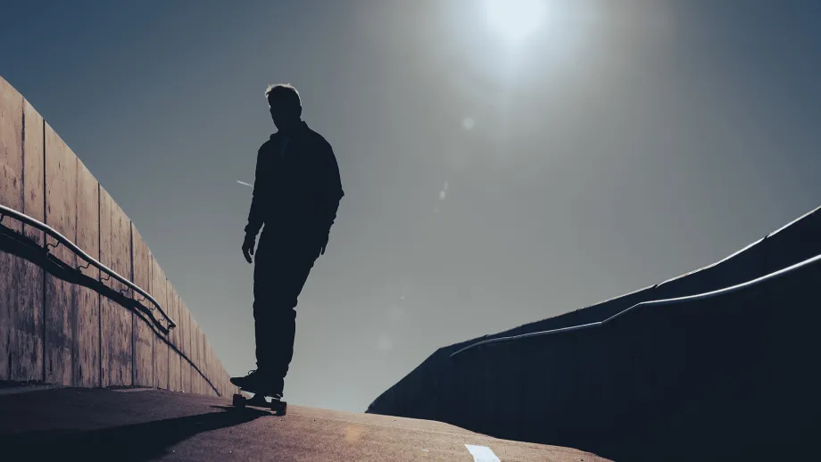 Silhouette of a skateboarder.
