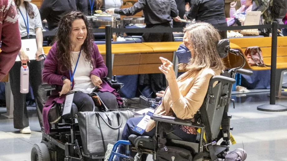 Two people in wheelchairs in discussion at the Accessible Futures Conference.