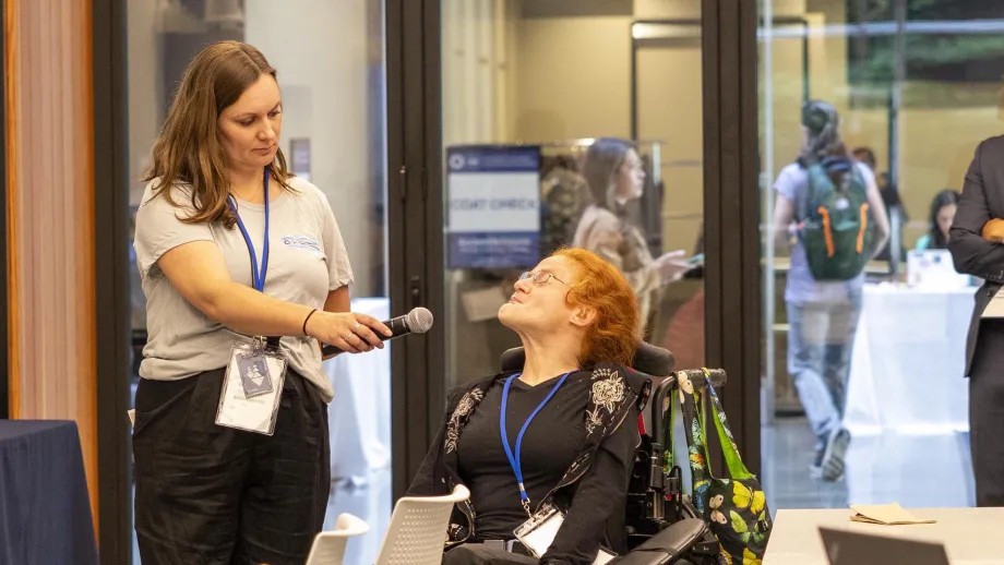 A disabled attendee at the Accessible Futures Conference speaks during a panel discussion.