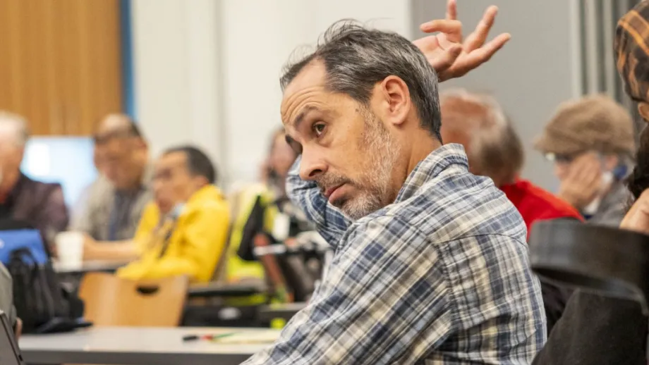 A participant raises his hand to speak at the Accessible Futures Conference.