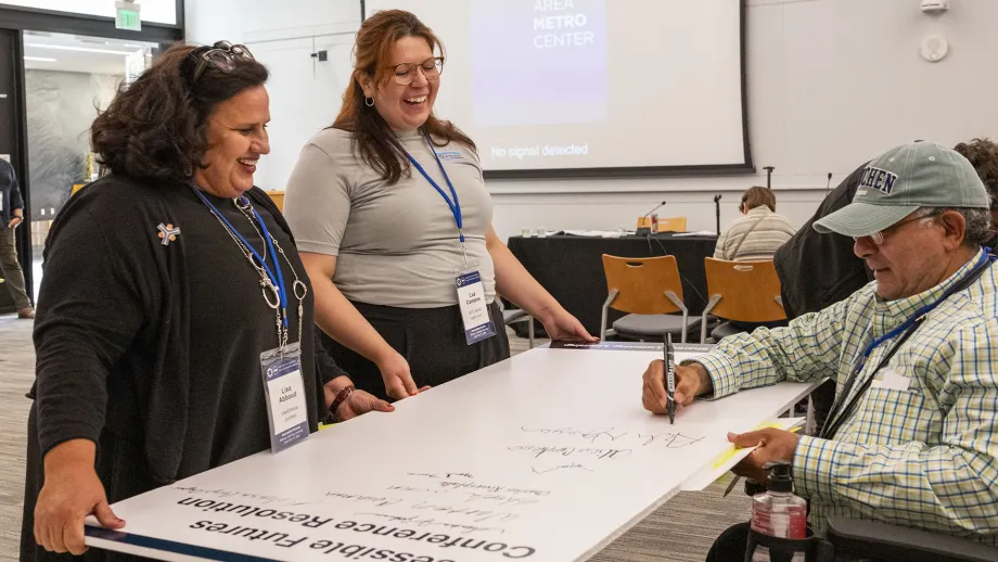 An Accessible Futures Conference attendee signing the conference resolution.