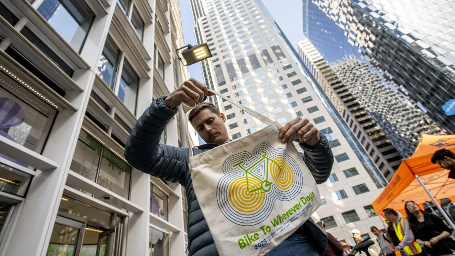 A person with a Bike to Wherever Days 2025 totebag in San Francisco.