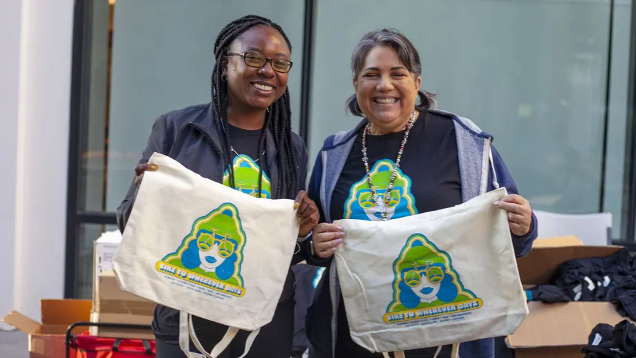 Two smiling women volunteering on Bike to Work Day.