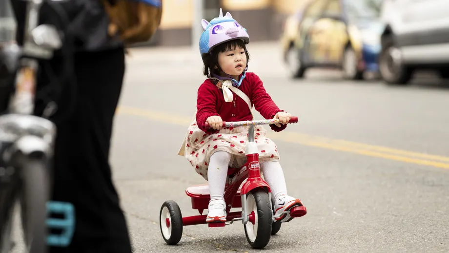 A young child on a tricycle on Bike to Work Day.