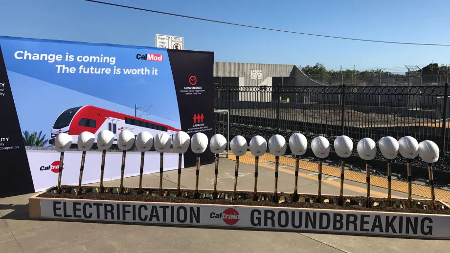 shovels standing upright in dirt with hardhats