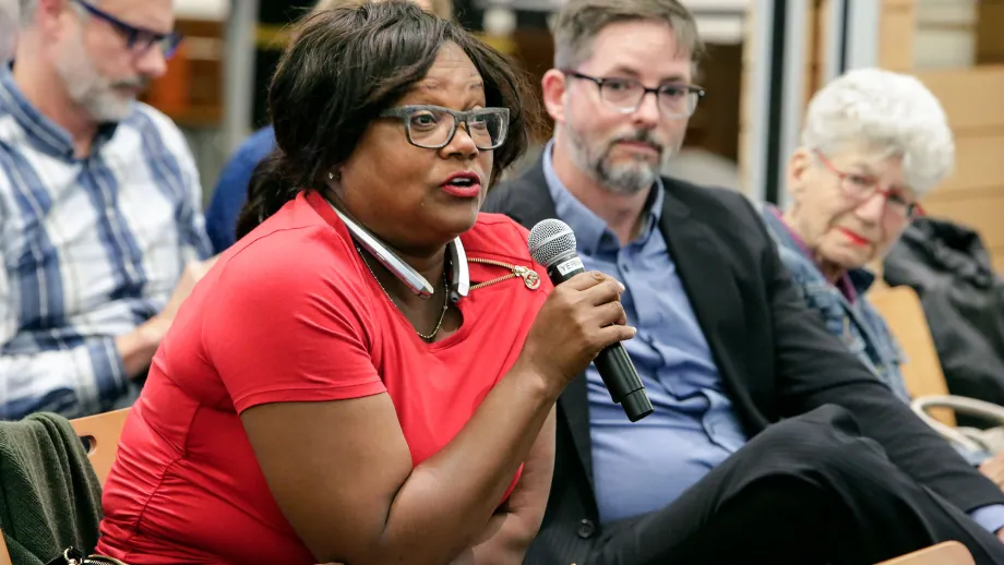 woman sitting in a chair with a microphone 