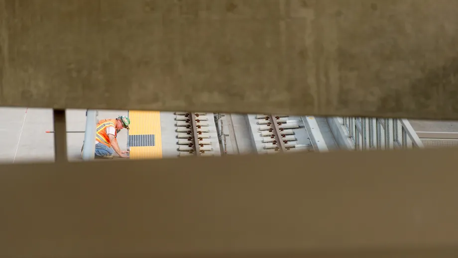 Warm Springs BART Station: Worker caulks a gap near the tracks.