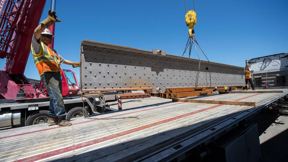 construction worker guiding a steel beam