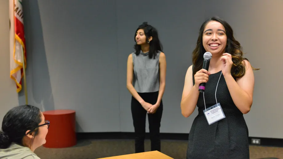 woman speaking into a microphone