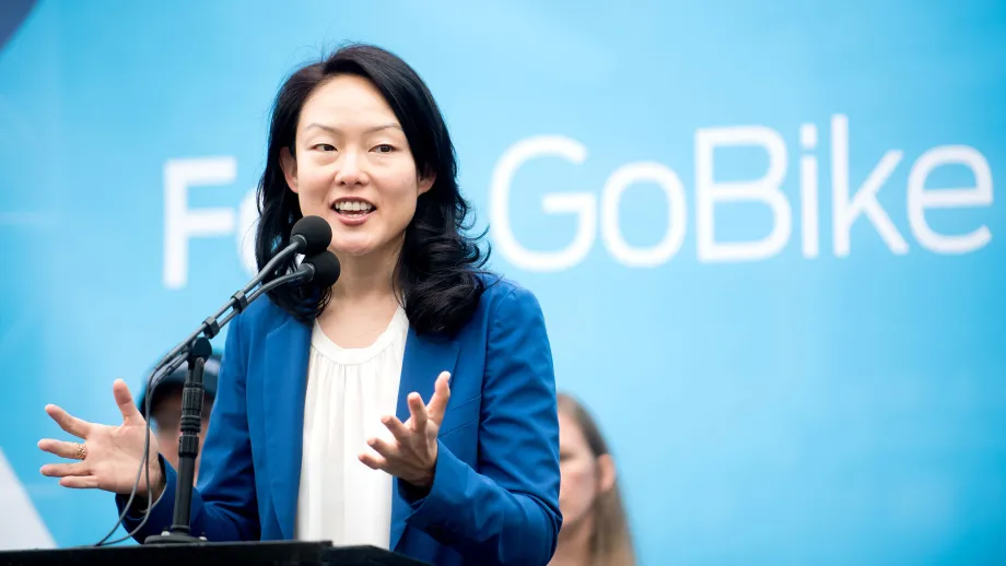 Woman at podium talking to a crowd