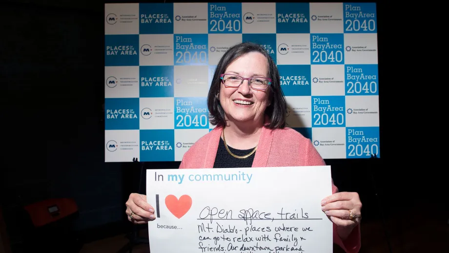 person holding a sign that reads I love my community because