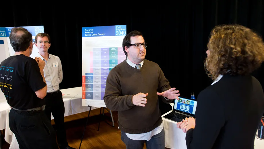 people talking in front of display boards