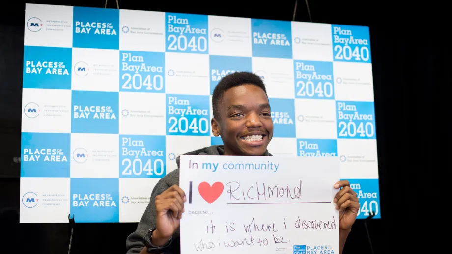 person holding a sign that reads I love my community because