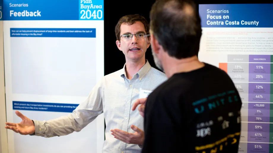 people talking in front of display boards