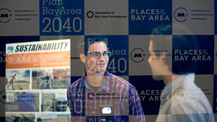 people talking in front of display boards