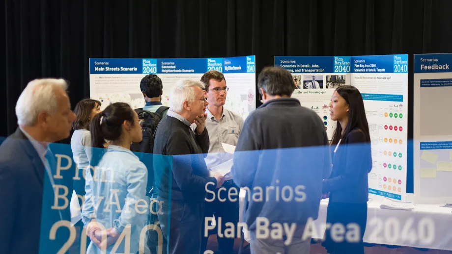 people talking in front of display boards