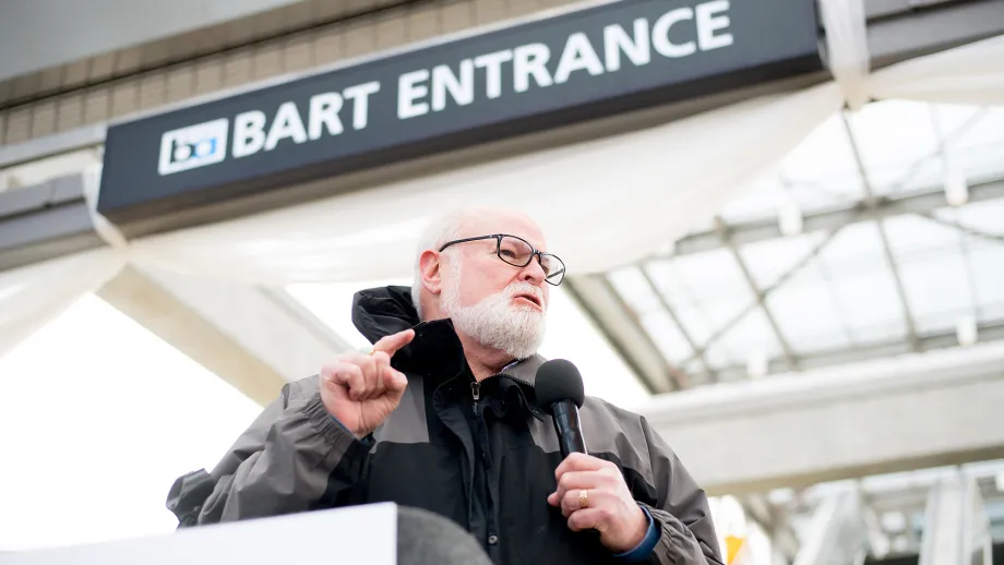 Man at podium talking to a crowd