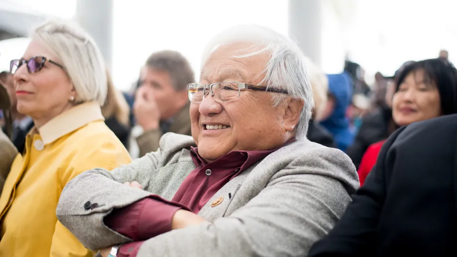 man smiling sitting in audience