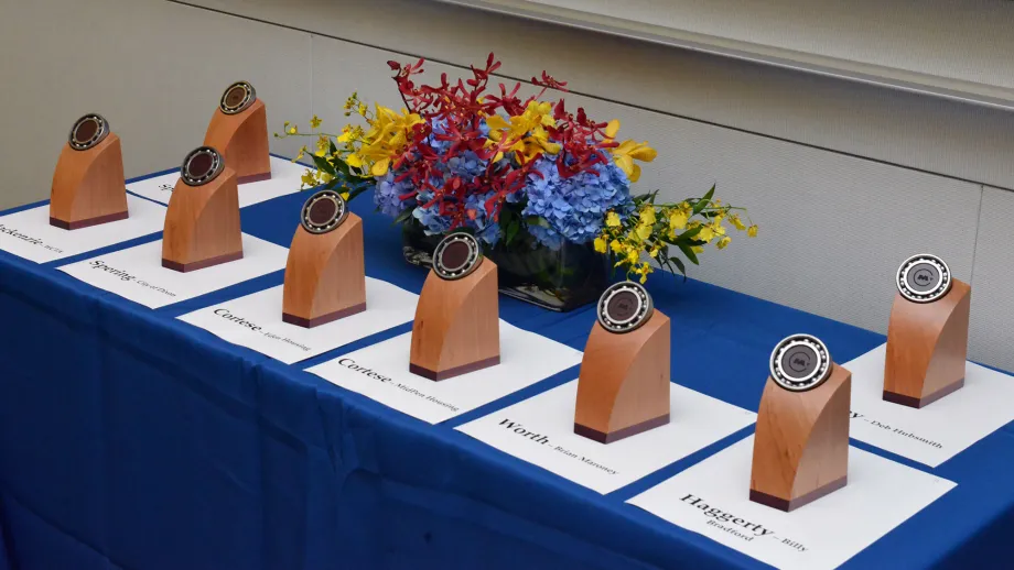 MTC Transportation Awards trophies sit on a table, each labelled with the name of the award presenter and winner.