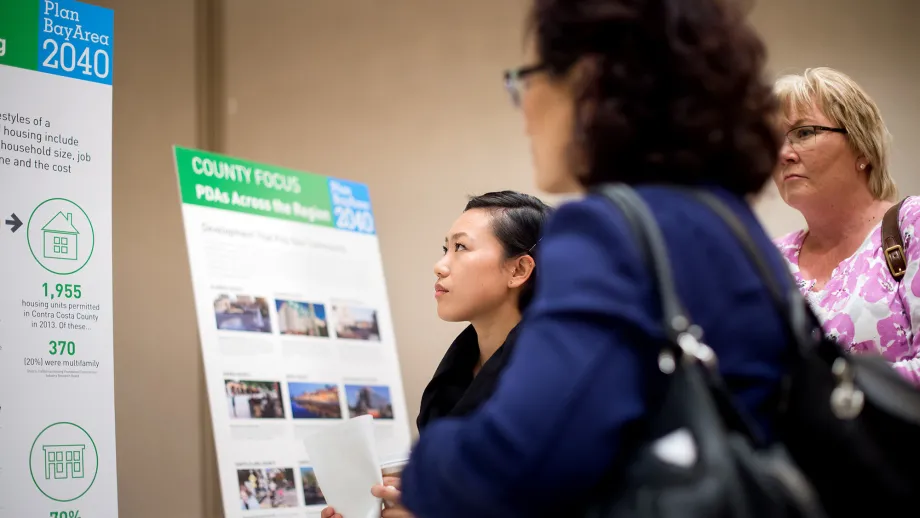 Members of the public examine a display