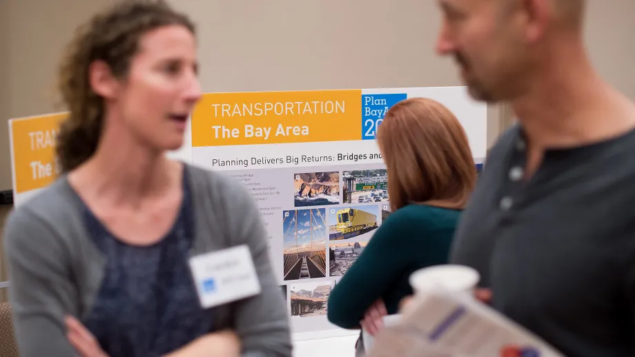 MTC staff member Carolyn Clevenger (left) speaks with an attendee.