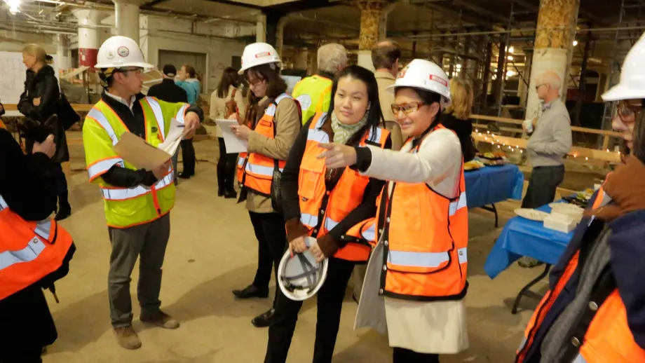 Nearby residents check up on the progress of the building, which is slated to open by summer 2015.