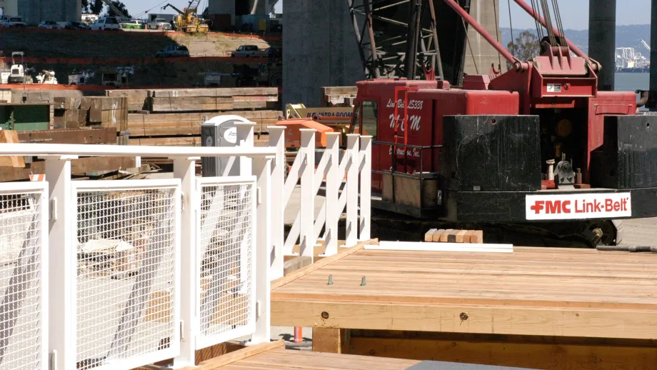 Crews prepare to install temporary bike path modules. 