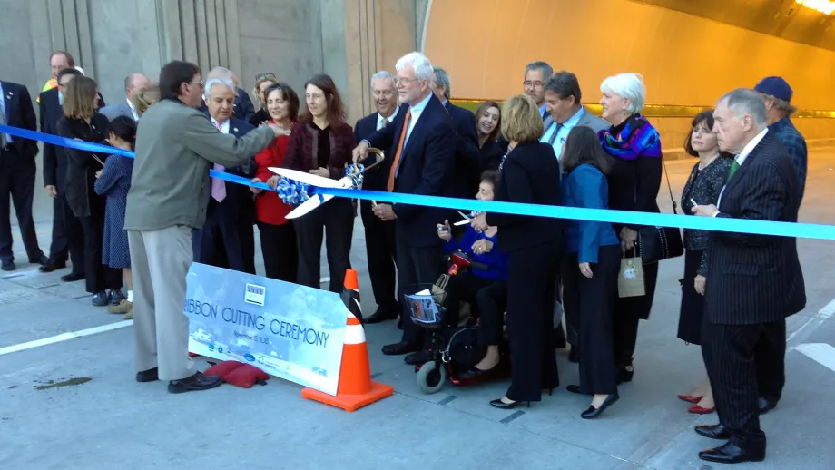 Congressman George Miller wields the ceremonial scissors.