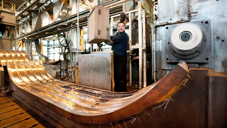 A machinist mills a piece of the Bay Bridge's steel saddle.