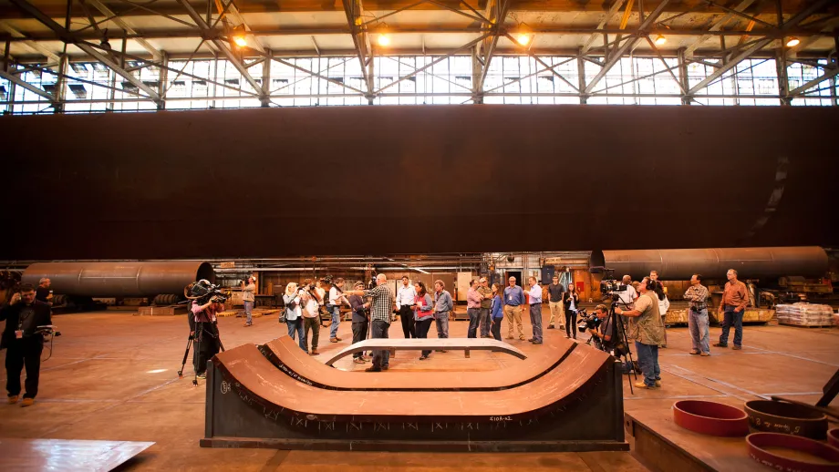 Journalists tour XKT Engineering's Vallejo, Calif., facility where pieces of the Bay Bridge's saddle, seen at bottom, are being fabricated.