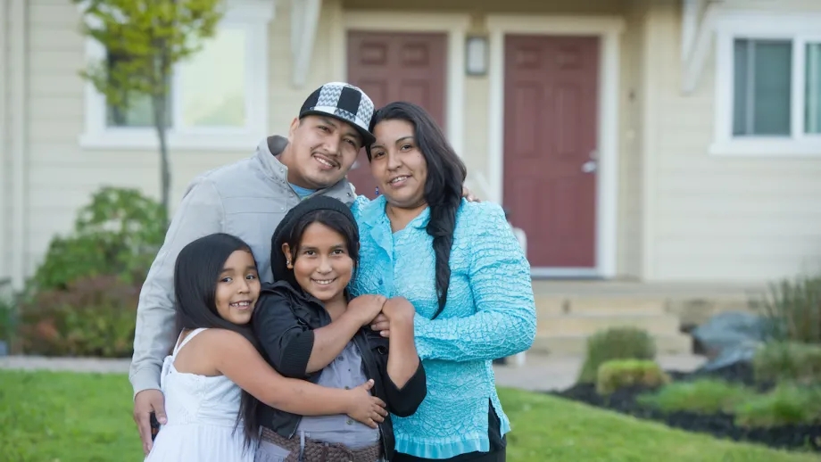 A happy family outside their home
