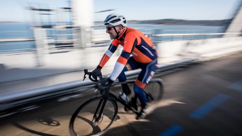 A cyclist zooms by on the bike/pedestrian path on the Richmond-San Rafael Bridge.