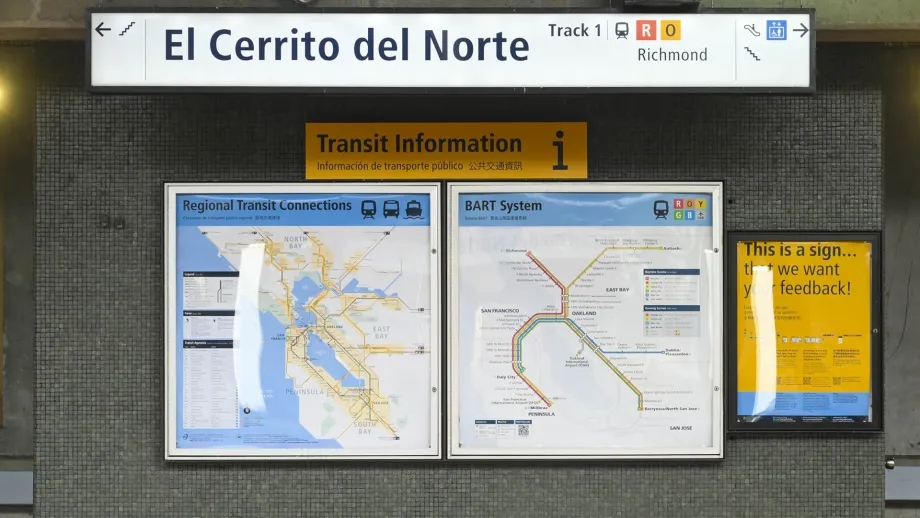 The Facility Name sign over the new Regional Transit Connections map and the BART system map.