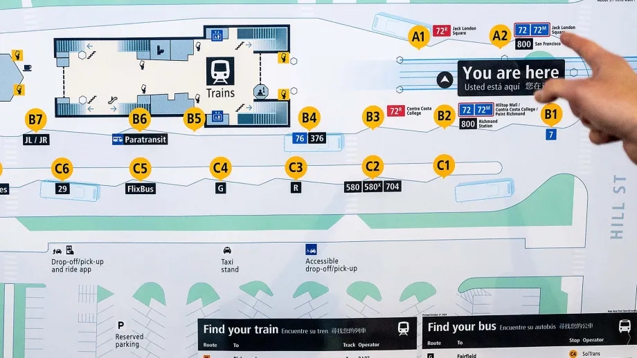 A person points at the new Facility Map at El Cerrito del Norte BART station.