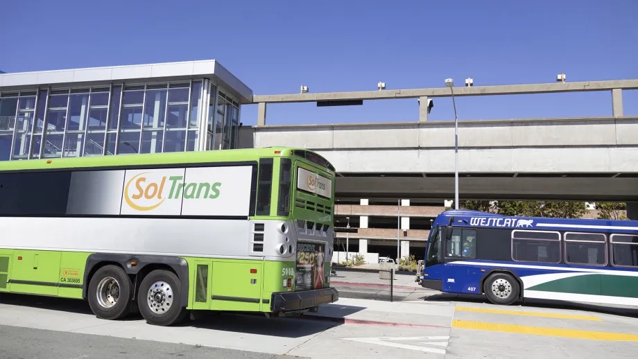 A SolTrans bus and a WestCAT bus at the El Cerrito del Norte BART station.
