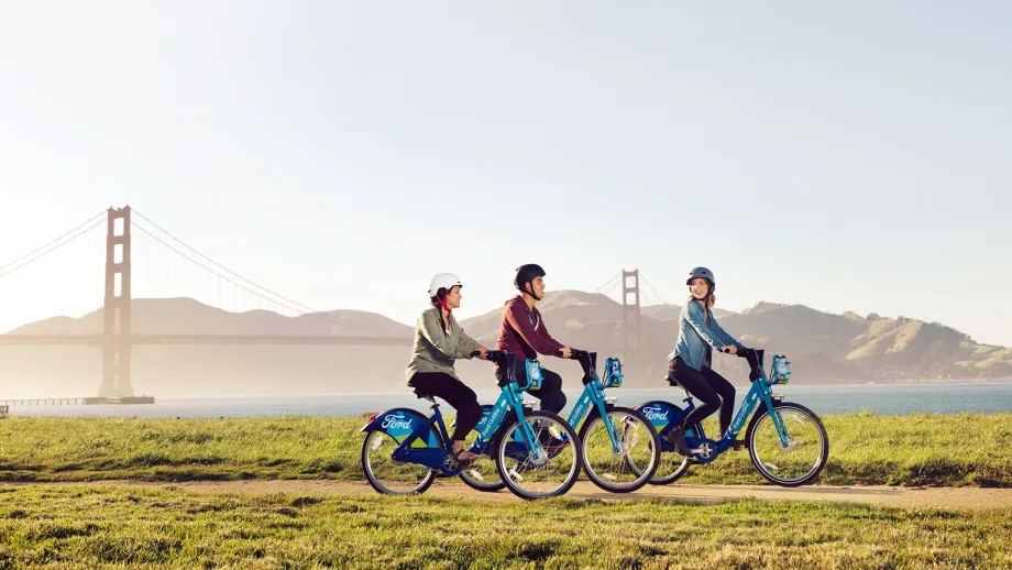 GoBike riders near the Golden Gate Bridge exchange pleasantries