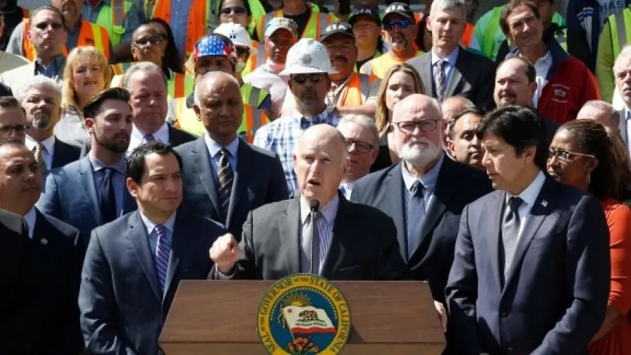 Calif., Gov. Jerry Brown, center, discusses a plan to raise $52 billion to fix California roads, during a news conference Wednesday, March 29, 2017, in Sacramento, Calif. (AP Photo/Rich Pedroncelli)