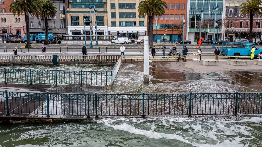 A king tide flooding the sidewalk of the Embarcadero in San Francisco.