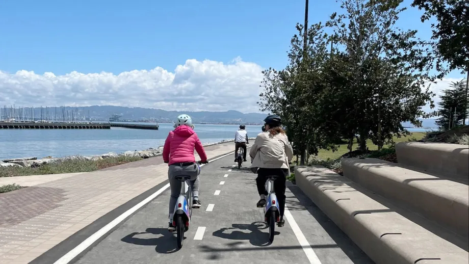 Bay Wheels bikes on a separated bike path with a view of the San Francisco Bay.